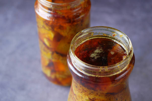 istock Homemade Mango Pickle in a glass jar on table , 1441995387