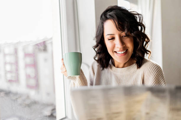 istock Morning cup of coffee while reading newspaper at home 1441995612