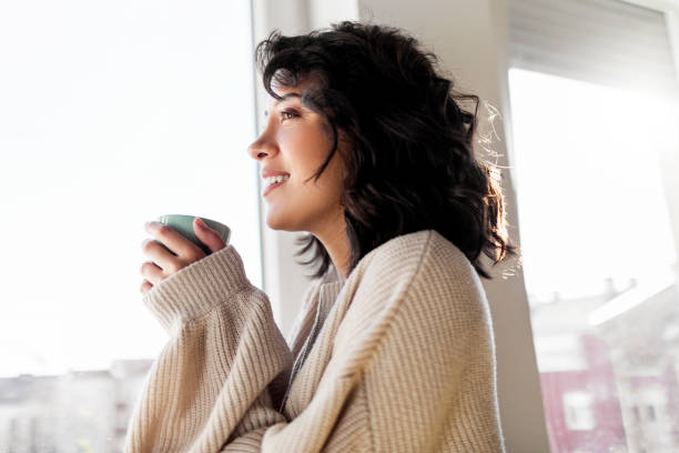 istock Young woman drinking cup of coffee 1441996161
