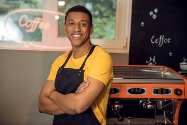 istock Smiling African American barista in the workplace 1441996577