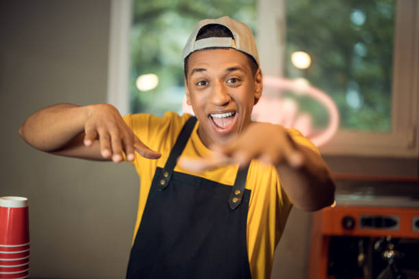 istock Happy cafe worker having fun in the workplace 1441996582