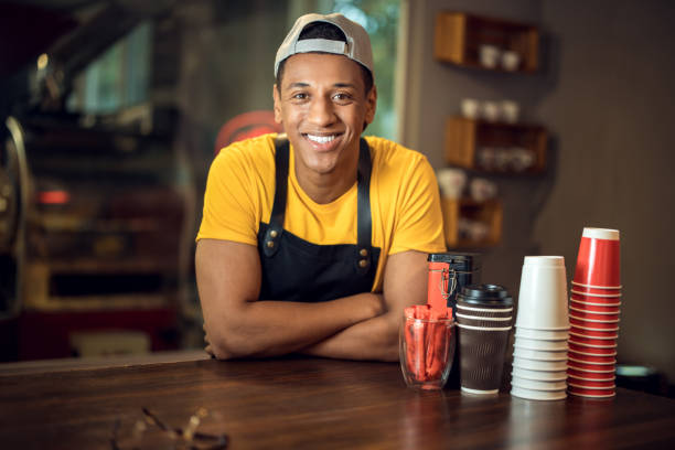 istock Joyful barista posing for the camera in a coffee shop 1441996589