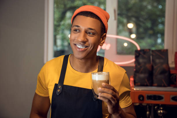 istock Smiling happy barista with a coffee drink 1441996662