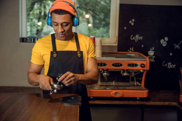 istock Professional barista making a caffeinated beverage to music 1441996822