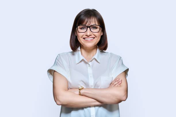 istock Attractive middle aged woman looking at camera on white background 1441997123