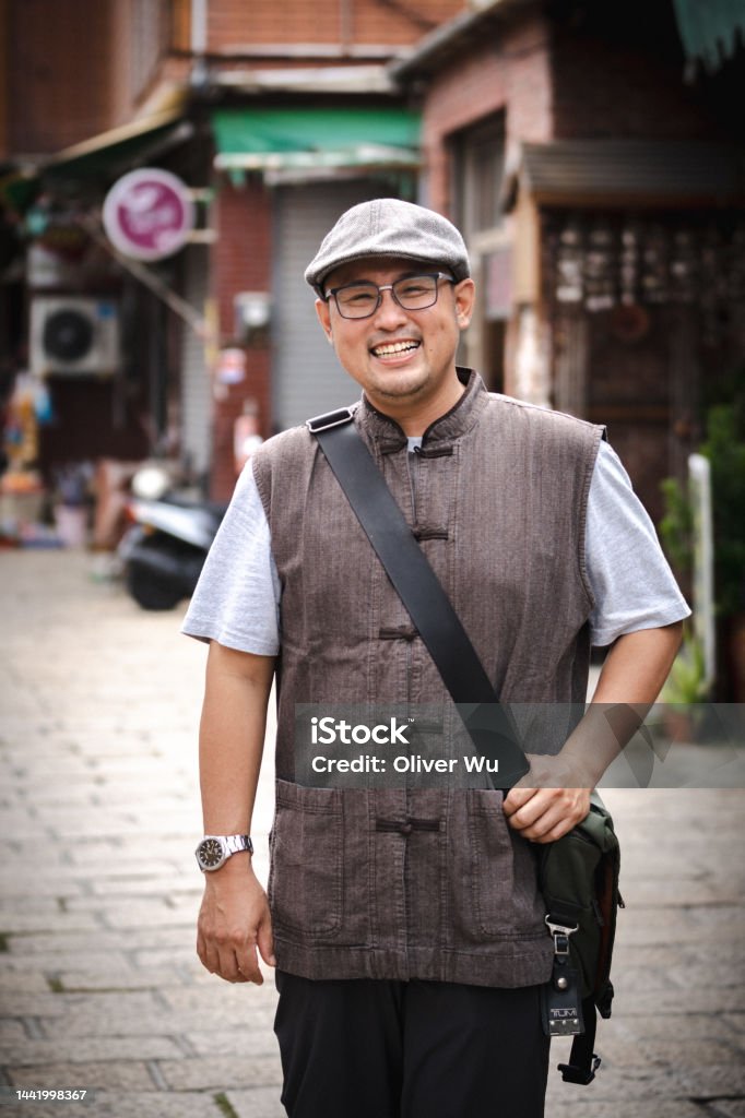A Local Tour Guide with Chinese Vintage Style Outfit A local tour guide with Chinese vintage style outfit in Lukang, Taiwan. 30-39 Years Stock Photo