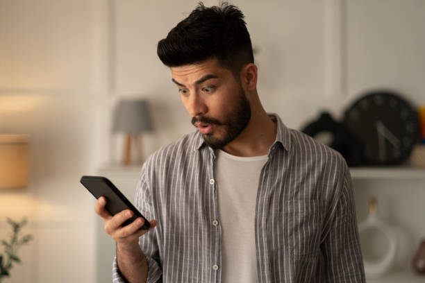 istock Man holding smartphone read unpleasant sms feels stressed 1442000984