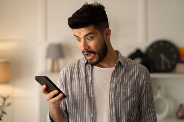 istock Man holding smartphone read unpleasant sms feels stressed 1442001062