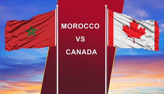 Morocco vs. Canada two flags on flagpoles and blue cloudy sky background.Soccer matchday template