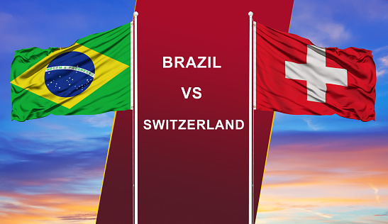 Brazil vs. Switzerland  two flags on flagpoles and blue cloudy sky background.Soccer matchday template