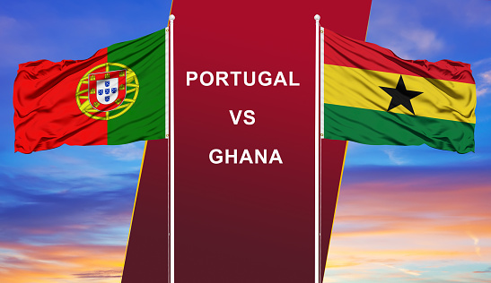 Portugal vs. Ghana two flags on flagpoles and blue cloudy sky background.Soccer matchday template