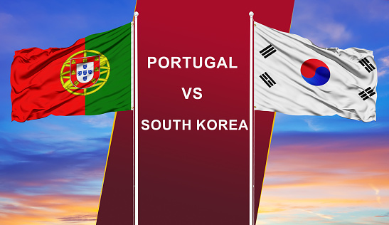 Portugal vs. South Korea two flags on flagpoles and blue cloudy sky background.Soccer matchday template