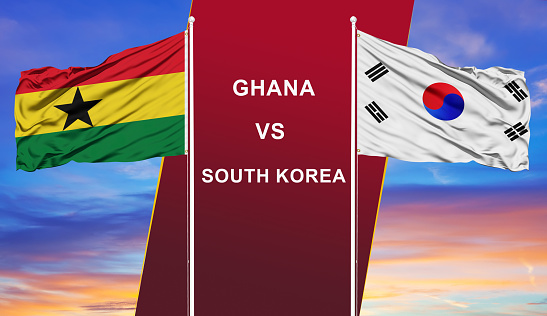 Ghana vs. South Korea two flags on flagpoles and blue cloudy sky background.Soccer matchday template