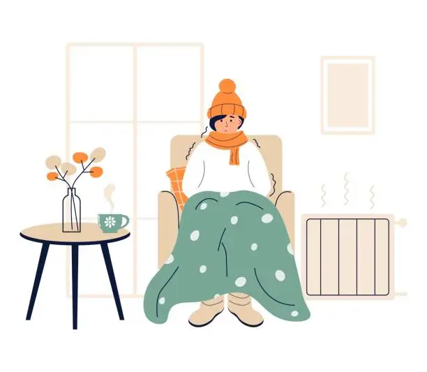 Vector illustration of Young woman wrapped in plaid. Low room temperature. Person freezes from cold indoors. Girl warming herself near heater. Character shivering from cold. Flat vector illustration on white background.