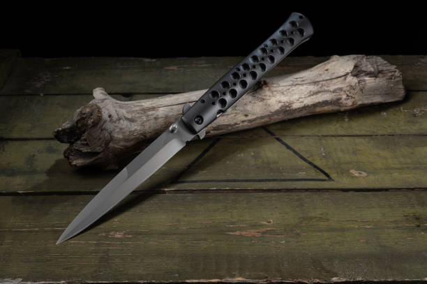 istock Large and narrow knife. Knife with double sharpened blade. Knife on a wooden stick. 1442005520
