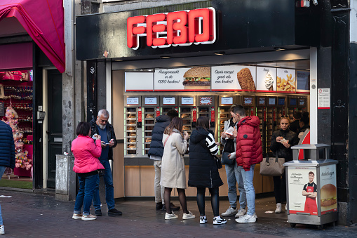 Amsterdam, Netherlands, November 13, 2022; Tourists in Amsterdam enjoy the hot snacks at the Automaten in a FEBO snack bar, such as hamburgers and croquettes.