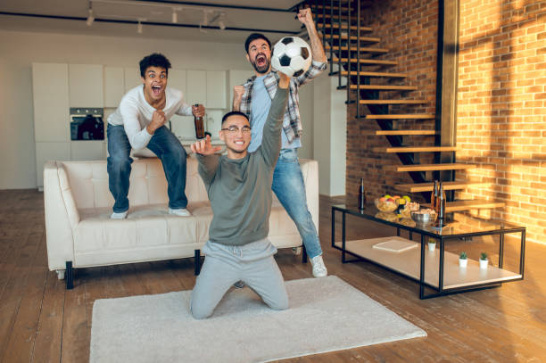 istock Emotional guys rooting for their favorite team 1442006990
