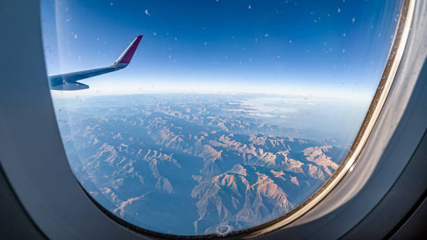 istock Mountain landscape from a height through the airplane porthole 1442007318