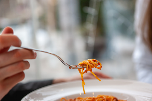 Bite of spaghetti on a fork, copy space