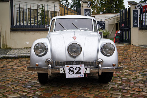 London, UK - 1 April, 2021: an old vintage white Cadillac car parked on a residential city street in London, UK.