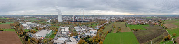 Drone panorama over German city Heilbronn with Neckar river Drone panorama over German city Heilbronn with Neckar river and combined heat and power plant during daytime in autumn heilbronn stock pictures, royalty-free photos & images