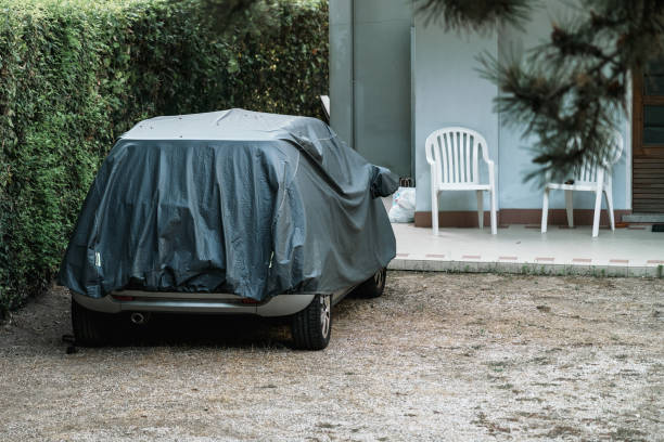 istock Car covering with tarpaulin material is parked at backyard. 1442018431