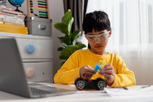 istock Asia students learn at home in coding robot cars and electronic board cables in STEM, STEAM, mathematics engineering science technology computer code in robotics for kids concept. 1442018715