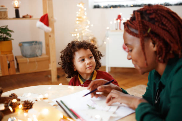 istock Mother and cute little son drawing together 1442023720