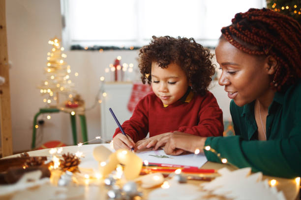 istock Mother and cute little son drawing together 1442023727