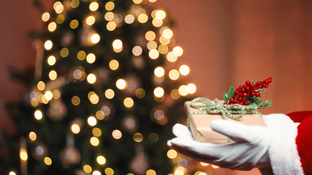 istock Santa Claus Gives Christmas Gift 1442024319