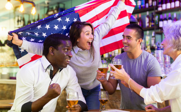 istock Diverse group celebrating with American flag 1442025754