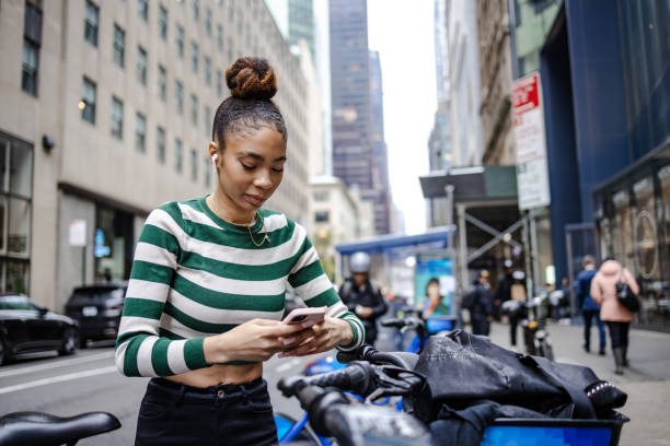 istock Young woman scanning a code for a sharing bike 1442027208