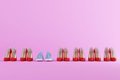 High heels on a pink background and sneakers.