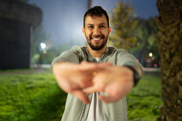 istock Athlete stretching arms at sports training at night 1442029970