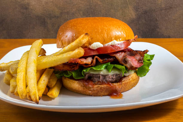istock bacon cheese burger  on a brioche bun  with fries 1442031984