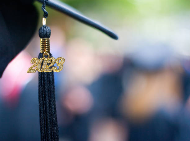 Class of 2023 Graduation Ceremony Tassel Black Closeup of a 2023 Graduation Tassel at a graduation ceremony. graduation hat stock pictures, royalty-free photos & images