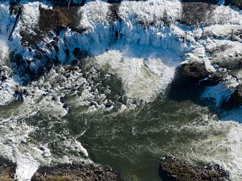 The Willamette Falls is a natural waterfall between West Linn and Oregon City, not far south of Portland, Oregon. By volume, this is the largest waterfall in the Northwestern United States.