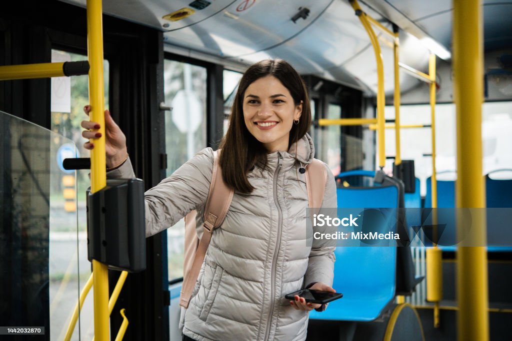 Student on public transport Young woman traveling by bus Bus Stock Photo
