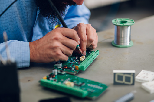 Electronics Engineering Work Environment Electronics Engineer Working In A Workshop With Tin Soldering Parts ...