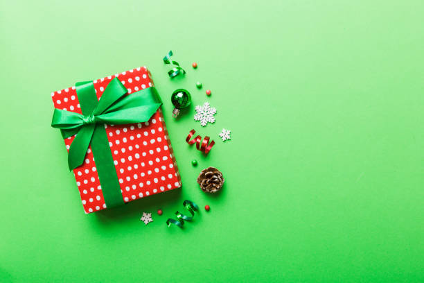 istock Top view Flat lay Christmas decorations and gift box on colored background with copy space. Christmas or Happy New Year composition 1442034441