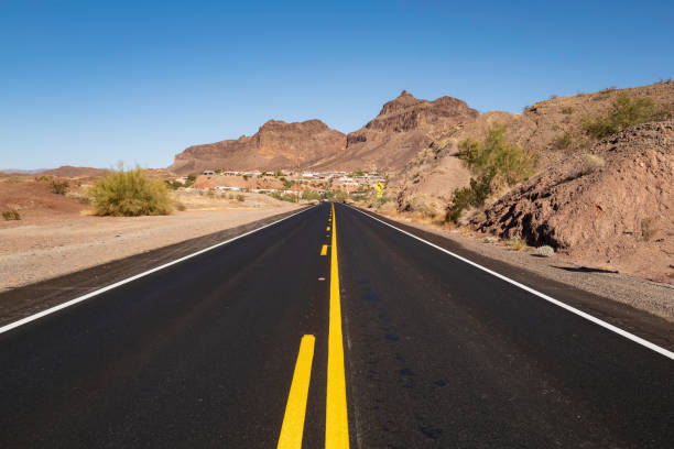 Road to the arid desert mountains at sunset in the Havasu City area along the Colorado River, Arizona, USA
