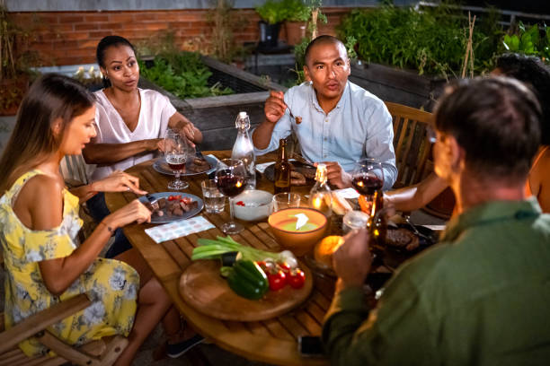istock Friends having a dinner party on rooftop 1442039665