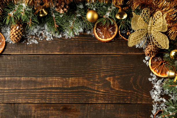 istock New Year and Christmas frame for text with a Christmas tree and colored Christmas decorations on a brown background. view from above. 1442040012