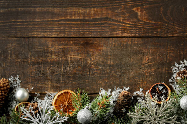 istock New Year and Christmas frame for text with a Christmas tree and colored Christmas decorations on a brown background. view from above. 1442040014