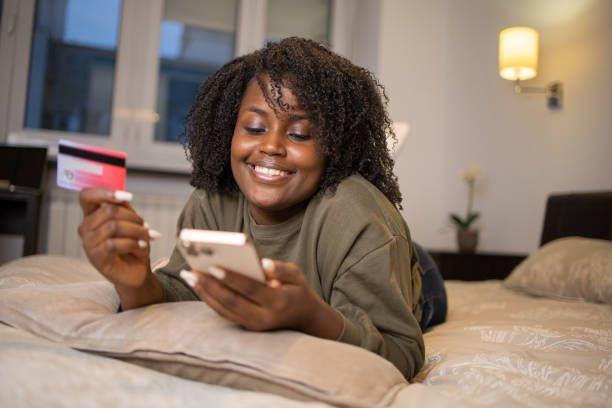istock Cheerful  woman doing online shopping 1442042385