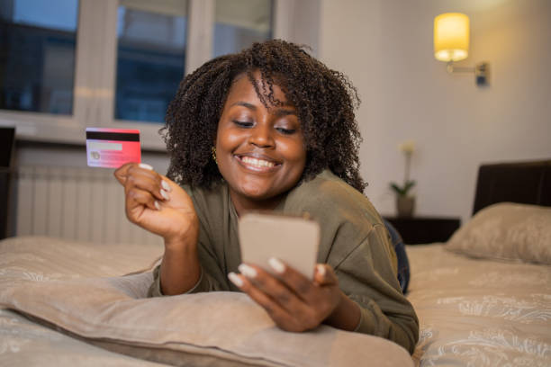 istock Cheerful  woman doing online shopping 1442042411