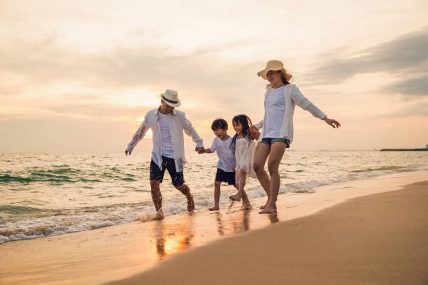 istock Happy family having fun running on a sandy beach at sunset time 1442061306