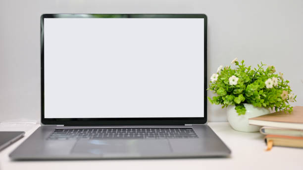 istock Notebook laptop white screen mockup is on the table with decor. close-up workspace 1442067047
