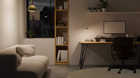 Minimal and cozy home office workspace at night with cozy couch, computer mockup and table lamp on desk, chair, shelves near the window and stylish pendant light. 3d render, 3d illustration