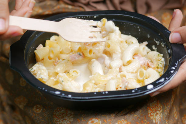 istock women eating take away cooked pasta in a plastic container 1442067800